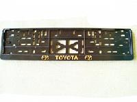 Рамка номера пластик с защелкой, черная, рельеф, TOYOTA  золото (уп.30 шт.)