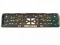 Рамка номера пластик с защелкой, черная, рельеф, MAZDA серебро (уп.30 шт.)